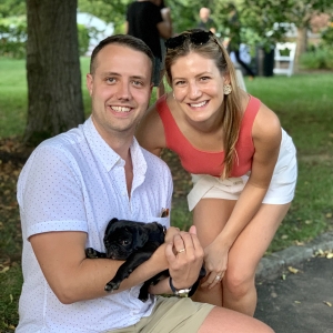 A couple holding a puppy